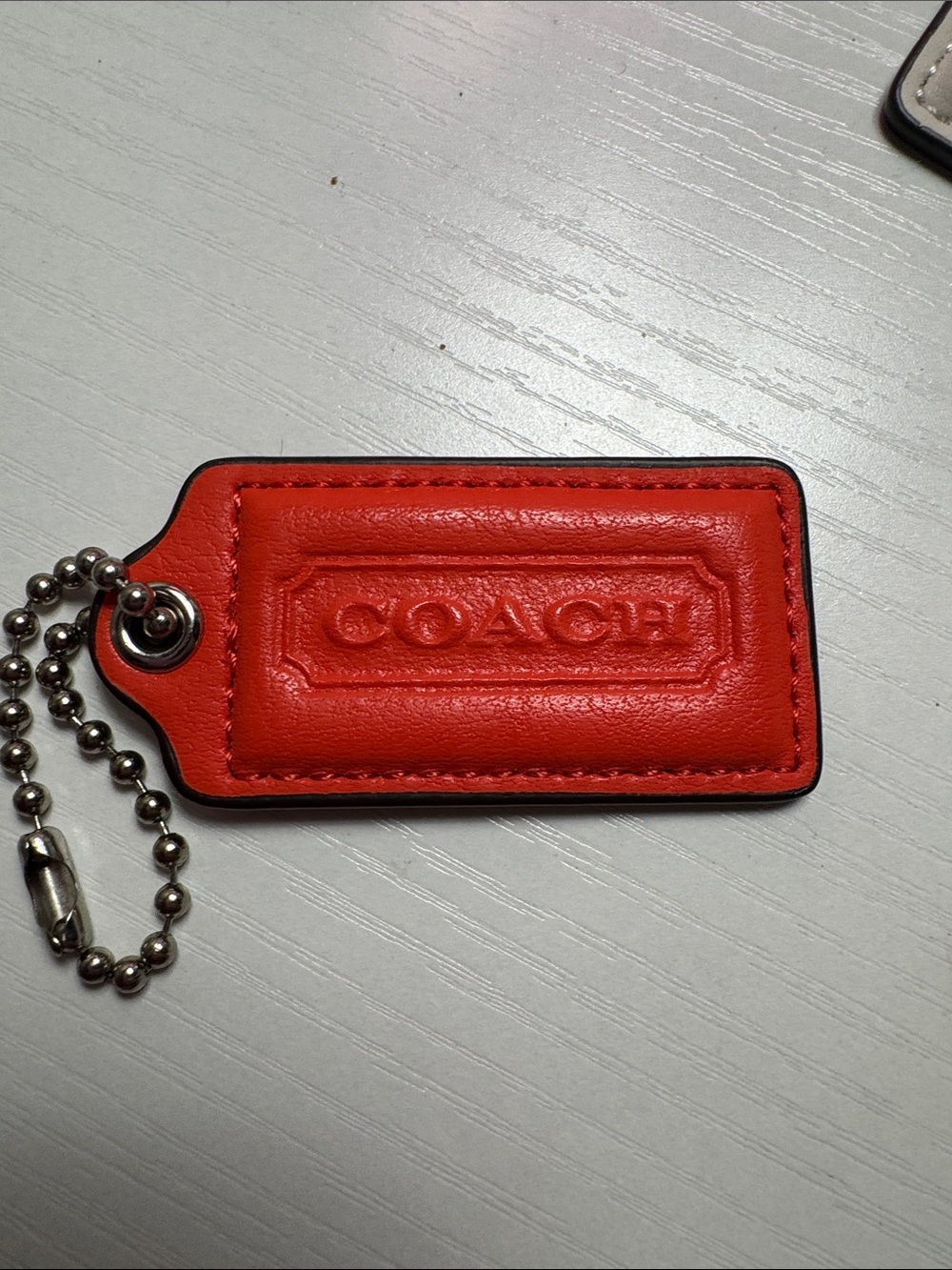 COACH Bright Orange/Red Leather Key Tag with Embossed Logo